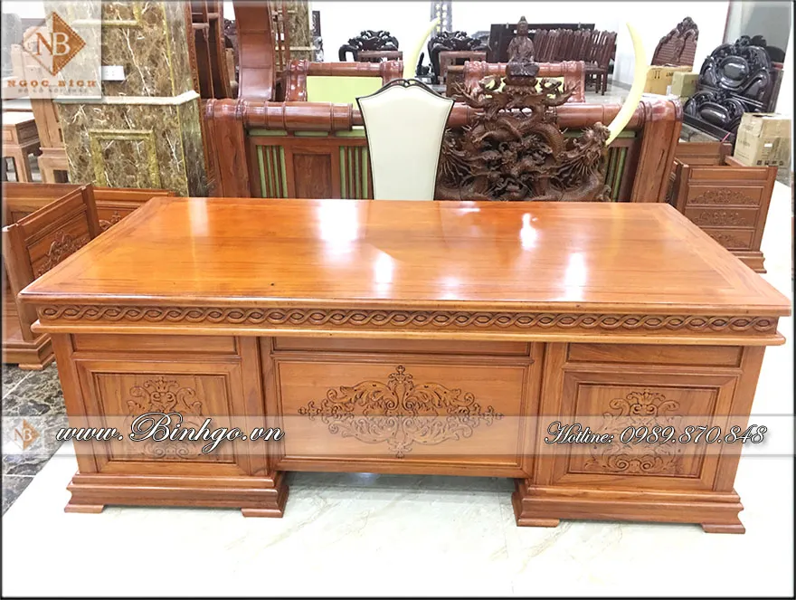 Phía trước bàn làm việc lãnh đạo gỗ tự nhiên, trang trí bằng 3 họa tiết hoa lá tây được hoàn thiện bằng tay bởi thợ lành nghề