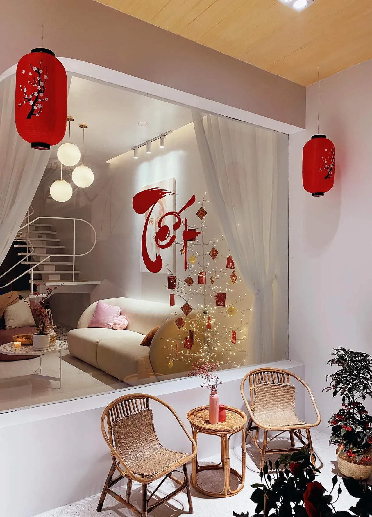 Trang trí những vách tường trống hoặc cửa kính với bộ giấy dán tường là phương án đem không khí xuân đến nhà bạn đơn giản và tiết kiệm nhất, kết hợp thêm lồng đèn treo cho không gian thêm phần điểm nhấn